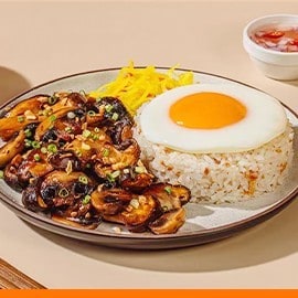 Soy-roasted mushrooms with garlic rice, fried egg, and atchara. Soy-roasted mushrooms with garlic rice, fried egg, and atchara.