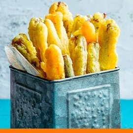Vegetable fritters with a side of salted egg sauce.  Vegetable fritters with a side of salted egg sauce.