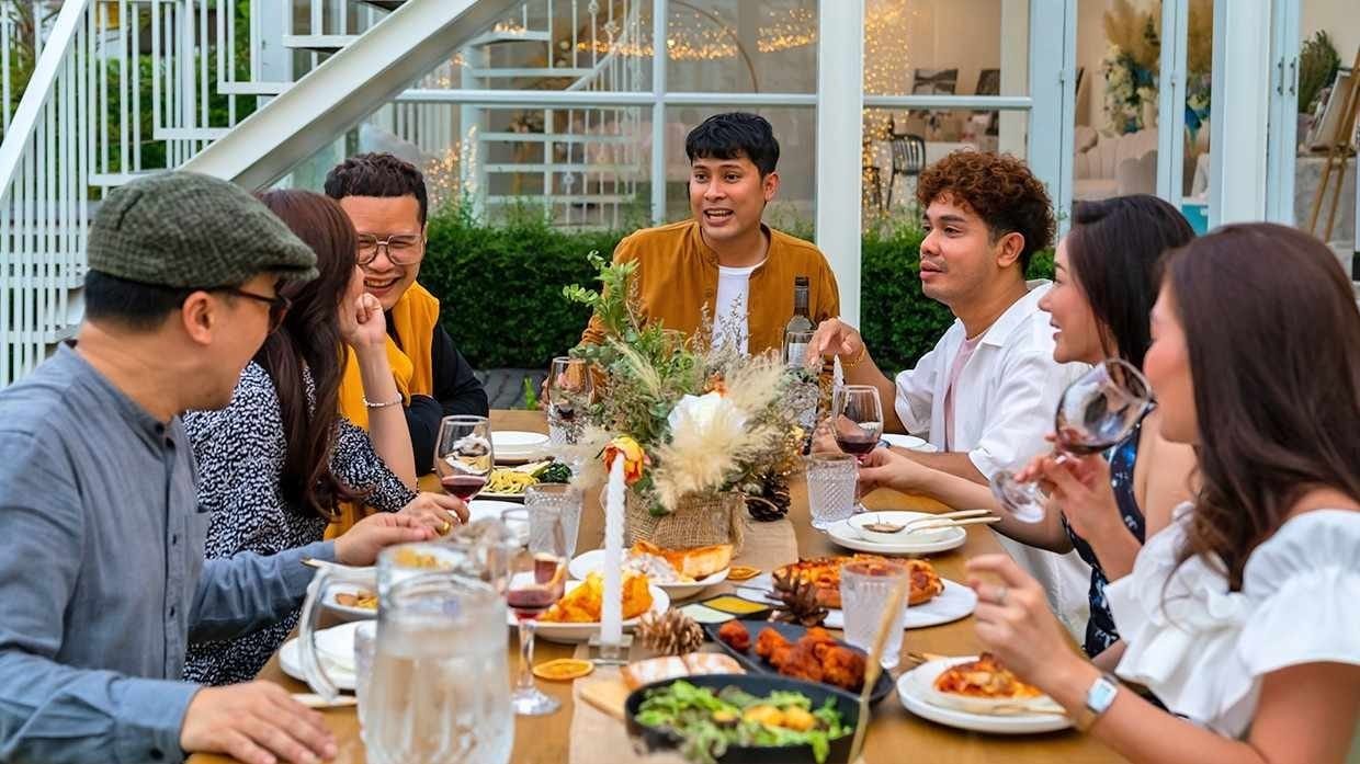 A diverse group of diners enjoying a meal together. A diverse group of diners enjoying a meal together.