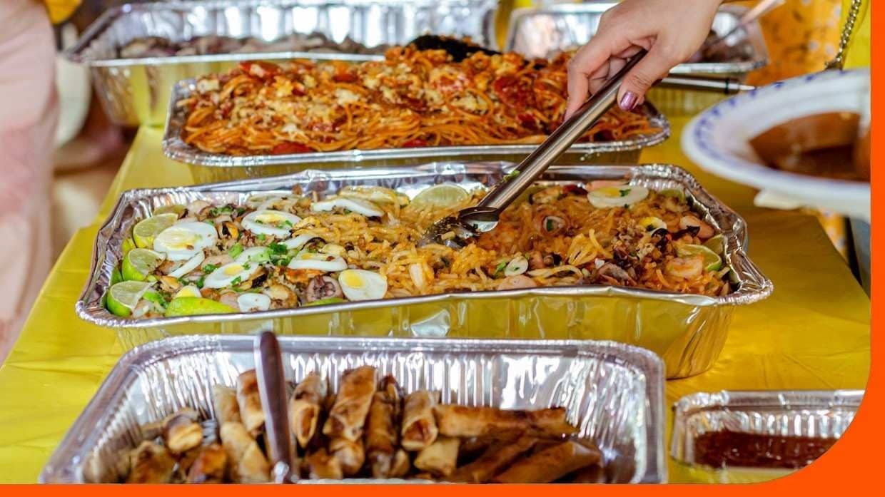 A buffet table featuring a variety of traditional Filipino dishes. A buffet table featuring a variety of traditional Filipino dishes.