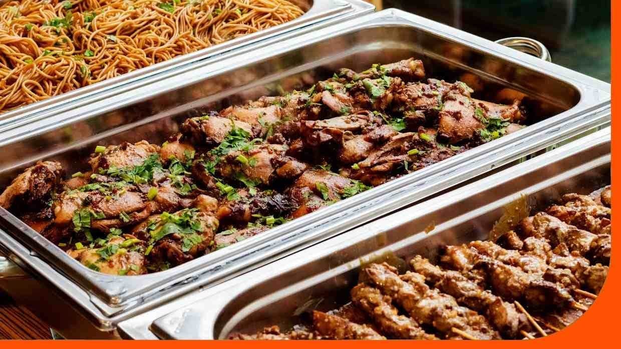 Various Filipino dishes in chafing dishes displayed for an event. Various Filipino dishes in chafing dishes displayed for an event.
